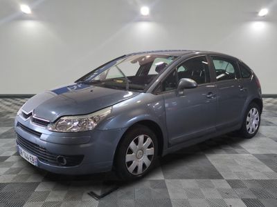 grey citrole parked in a room with checkered flooring