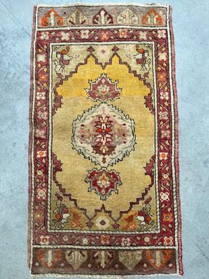 a yellow and red rug sitting on top of a blue floor