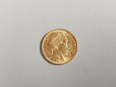 a close up of a gold coin on a white surface