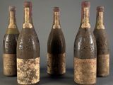 four bottles of wine are lined up in a row