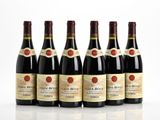 six bottles of red wine lined up in a row