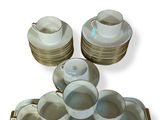 a tray with cups and saucers and a tray with plates on it