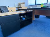 a desk and chair in an office with a blue carpet