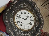 a table with a clock, plates and a bowl on it