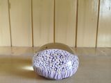 a small purple and white object on a table