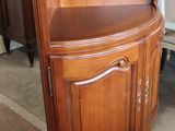 a corner cabinet in the middle of a room