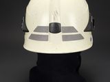 a white helmet with a black base on top of a mannequin head