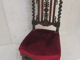 a red chair that is sitting on a white floor