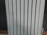 a white radiator sitting on a wooden floor next to a wall