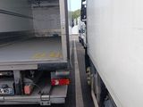a truck that is parked next to another truck