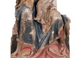 an old statue of a woman with a child on her lap