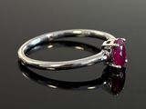 an image of a close up of a ring with a ruby stone on it
