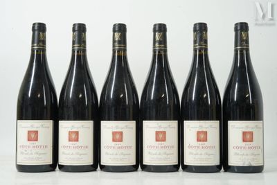 six bottles of wine are lined up on a table
