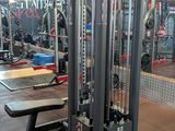 a gym with a bunch of machines in the room