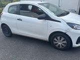 a picture of a small white car parked on the side of the road