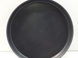 an image of a black pan sitting on a white surface