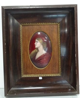 an old picture of a woman in a red dress in a wooden frame