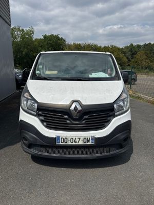 the front of a white van parked in a parking lot next to a building