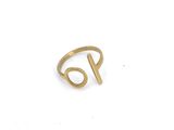 a close up of a gold ring on a white surface