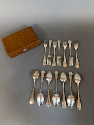 a lot of forks and spoons that are on the table