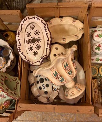 une boîte en bois remplie d'assiettes et de bols de toutes sortes