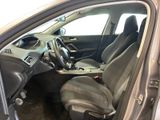 the interior of a car with the door open and the driver ' s seat down
