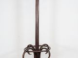 an image of a coat rack on a brick floor in a room