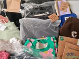 many bags of clothing and bags of clothing on the table