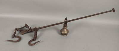 an old metal object on a white surface with a hook and a hammer