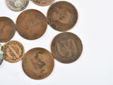 a lot of coins that are on a white surface