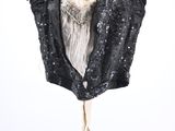 the back of a black top with sequins on it hanging on a hanger