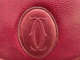 a close up of a red purse with a logo on it