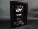 a black framed picture of a pair of boxing gloves