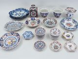 many different types of plates and bowls on the table