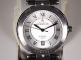 a close up of a wrist watch with roman numerals