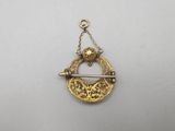 a gold plated broochle with an arrow on it
