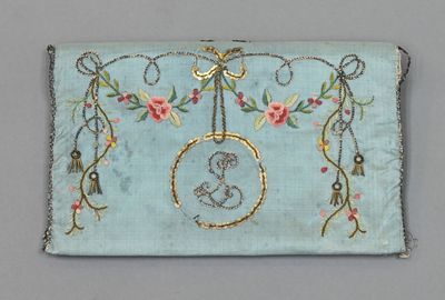 un sac à main brodé, orné d'un oiseau et de fleurs suspendus sur le côté