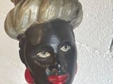 a statue of a woman with a hat on top of her head