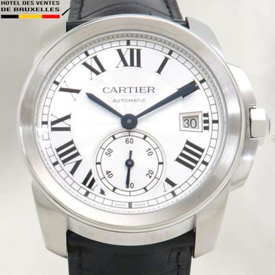 a silver wrist watch with roman numerals on it