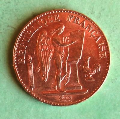 an image of a penny with a statue on it on a green surface