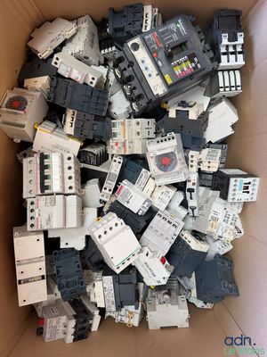 a box full of old and new circuit breakers in a cardboard box