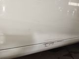 a close up of a white car that has been dented