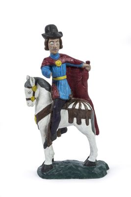 figurine représentant un homme à cheval, vêtu d'une cape et coiffé d'un haut-de-forme