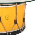 yellow and black drum with a glass top on a white background