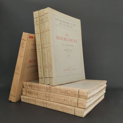 several books stacked on top of each other on a table