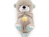 a stuffed animal that is laying down on a white surface