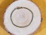 a picture of a wooden slice with a ring on it