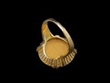 a close up of a gold ring on a black background