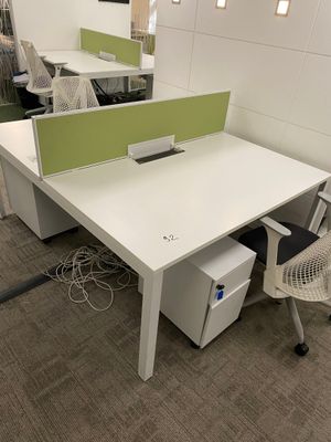 a white desk with a chair and a computer on it