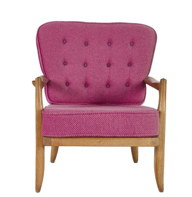 a pink chair with a wooden frame and a pink cushion